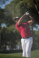 Image showing golfer hitting a sand bunker shot