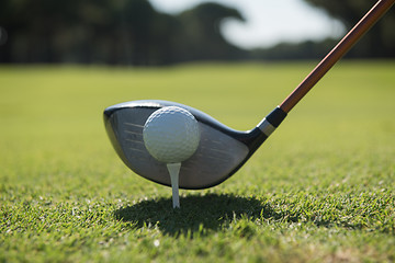 Image showing golf player placing ball on tee