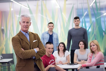 Image showing portrait of  teacher with students group in background