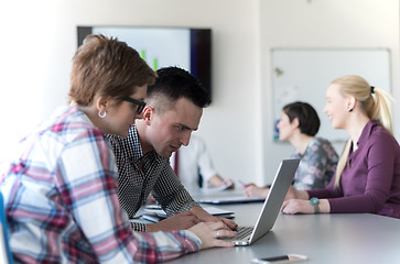 Image showing young business couple working on laptop, businesspeople group on