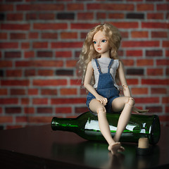 Image showing doll with a bottle. the concept of alcoholism