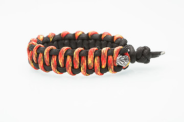 Image showing black and orange braided bracelet on white background