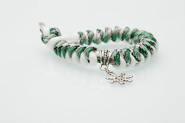 Image showing green braided bracelet on white background