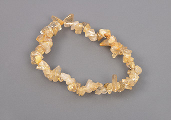 Image showing Splintered rutile quartz chain on gray background