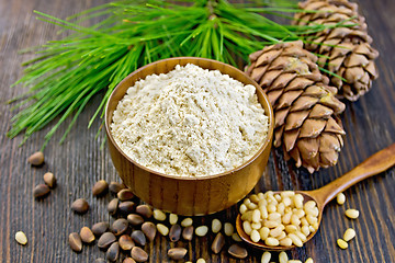 Image showing Flour cedar in wooden bowl with spoon on board