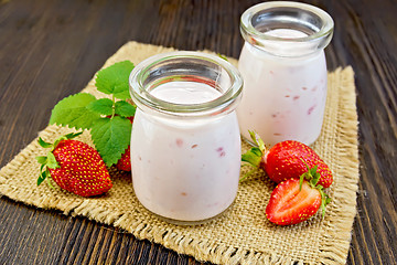 Image showing Yogurt with strawberries in jars on sacking