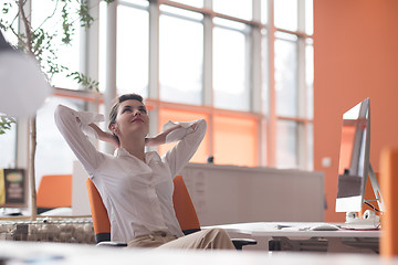 Image showing happy young business woman relaxing and geting insiration