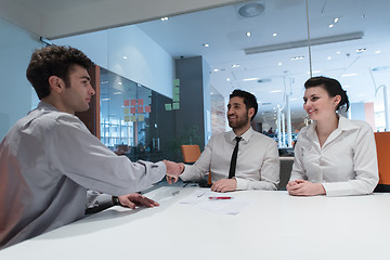 Image showing young couple signing contract documents on partners back