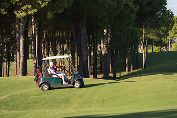 Image showing couple in buggy on golf course