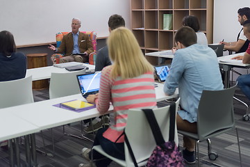 Image showing teacher with a group of students in classroom