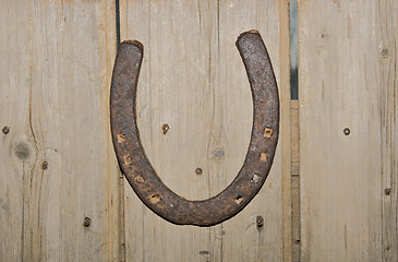 Image showing old horshoe on wooden wall