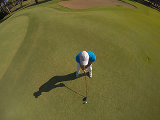 Image showing top view of golf player hitting shot