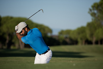 Image showing pro golfer hitting a sand bunker shot
