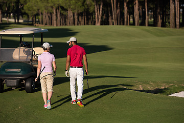 Image showing couple walking on golf course