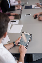 Image showing close up of  businessman hands  using tablet on meeting