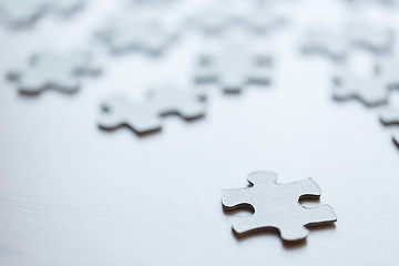 Image showing close up of puzzle pieces on table