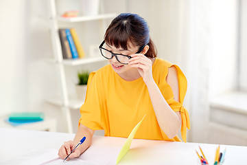 Image showing happy asian young woman student learning at home