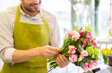 Image showing close up of florist man with bunch at flower shop