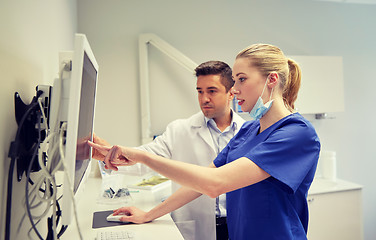 Image showing dentists with x-ray on monitor at dental clinic