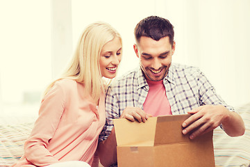 Image showing happy couple with parcel box at home