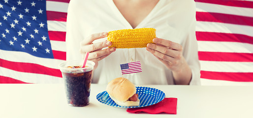 Image showing woman hands holding corn with hot dog and cola