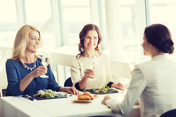 Image showing happy women drinking champagne at restaurant