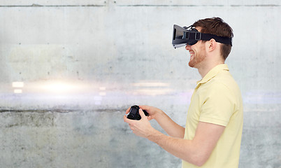 Image showing man in virtual reality headset and gamepad playing