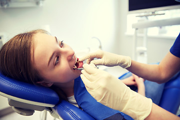 Image showing female dentist checking patient girl teeth