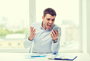 Image showing close up of businessman with smartphone