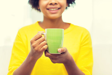 Image showing happy african american woman drinking from tea cup