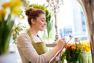 Image showing florist woman with clipboard at flower shop