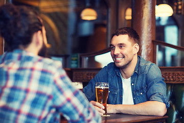 Image showing happy male friends drinking beer at bar or pub