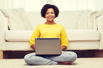 Image showing happy african american woman with laptop at home