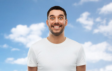 Image showing man with funny face over blue sky background