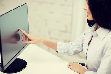 Image showing close up of woman with computer monitor in office