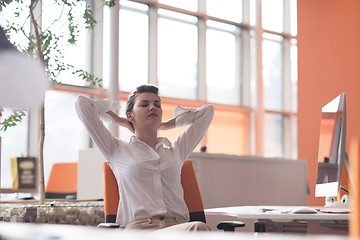 Image showing happy young business woman relaxing and geting insiration