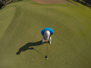 Image showing top view of golf player hitting shot