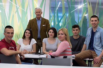 Image showing portrait of  teacher with students group in background