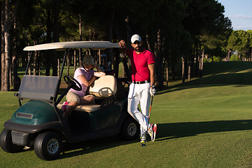 Image showing couple in buggy on golf course