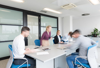 Image showing business people group entering meeting room, motion blur