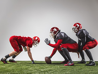 Image showing The three american football players in action