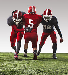 Image showing The three american football players in action