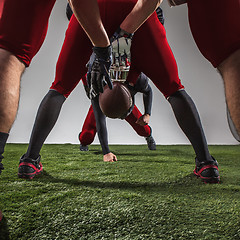 Image showing The three american football players in action