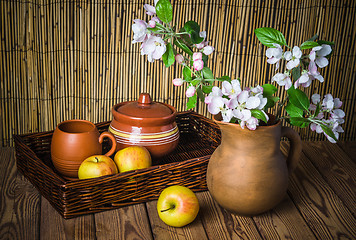 Image showing Ripe apple and blossoming branch of an apple-tree in a clay jar,