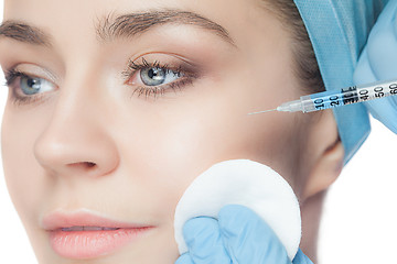 Image showing Attractive woman at plastic surgery with syringe in her face