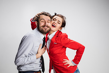 Image showing The business man and woman embracing on a gray background