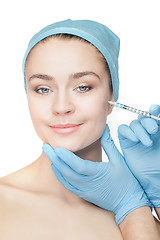 Image showing Attractive woman at plastic surgery with syringe in her face