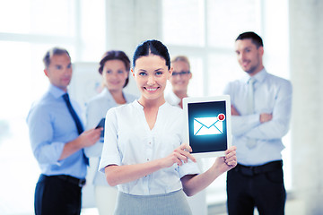 Image showing businesswoman holding tablet pc with email sign