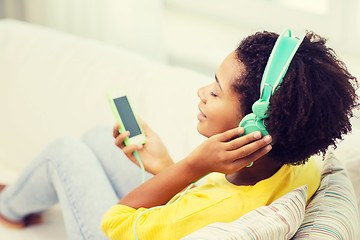 Image showing happy african woman with smartphone and headphones