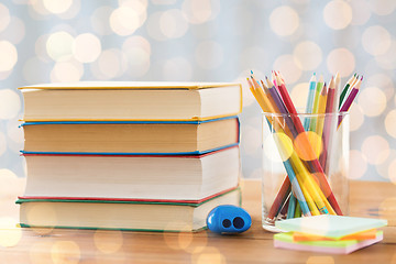 Image showing close up of crayons or color pencils and books